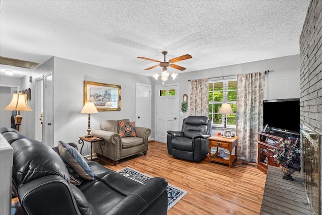 4042 Village Dr, Cohutta, GA 30710 - living room featuring ceiling fan, light wood-style flooring, and a textured ceiling