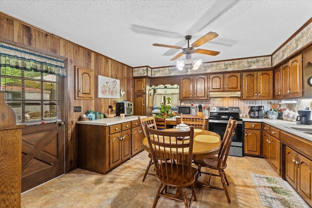 4042 Village Dr, Cohutta, GA 30710 - kitchen with a ceiling fan, stainless steel appliances, a textured ceiling, wood walls, and under cabinet range hood