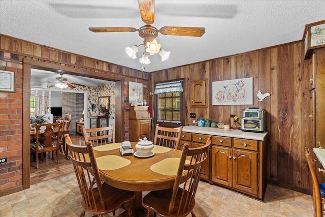 4042 Village Dr, Cohutta, GA 30710 - dining area with a ceiling fan, a healthy amount of sunlight, wood walls, and a textured ceiling