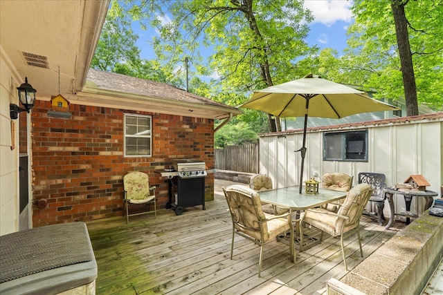 4042 Village Dr, Cohutta, GA 30710 - wooden deck featuring area for grilling, visible vents, fence, and outdoor dining space