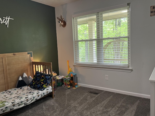 carpeted bedroom featuring baseboards