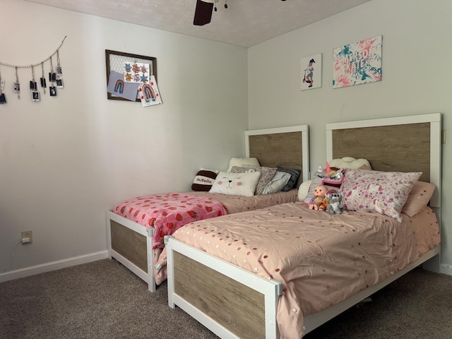 carpeted bedroom featuring baseboards and a ceiling fan