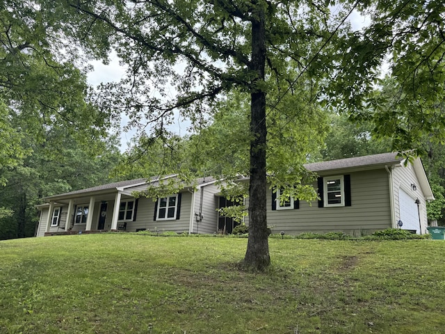 single story home with a front yard and an attached garage
