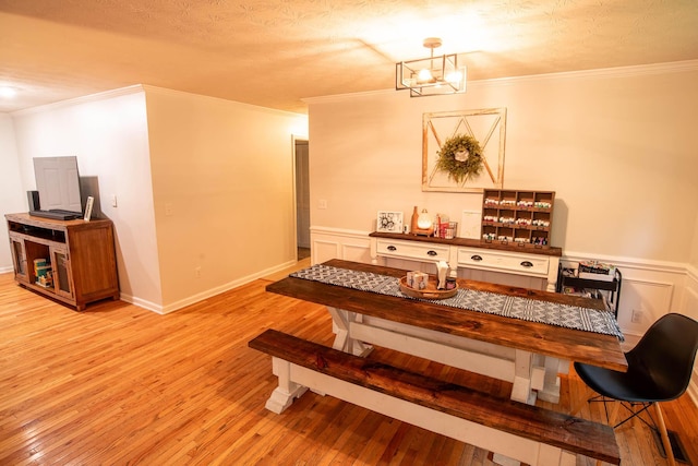 2752 Swanson Rd, Ringgold, GA 30736 - dining space with light wood-type flooring, a chandelier, wainscoting, and crown molding