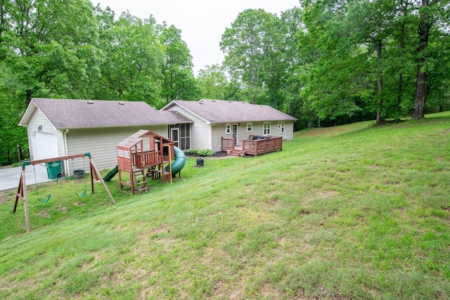 2752 Swanson Rd, Ringgold, GA 30736 - rear view of house featuring a garage, a deck, a yard, a playground, and view of scattered trees
