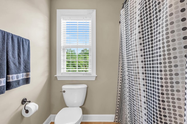 8358 Front Gate Cir, Ooltewah, TN 37363 - bathroom with curtained shower, toilet, and baseboards
