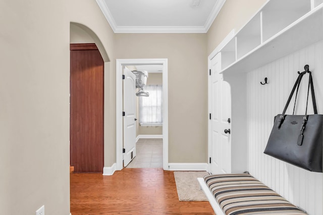8358 Front Gate Cir, Ooltewah, TN 37363 - mudroom featuring crown molding, wood finished floors, arched walkways, and baseboards