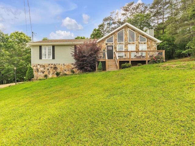 view of front of house with stone siding, a deck, a chimney, and a front yard