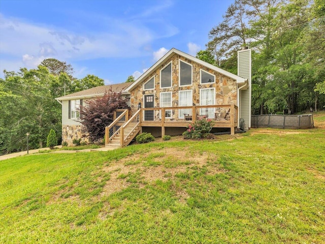 rear view of property featuring stone siding, a deck, a chimney, and stairway