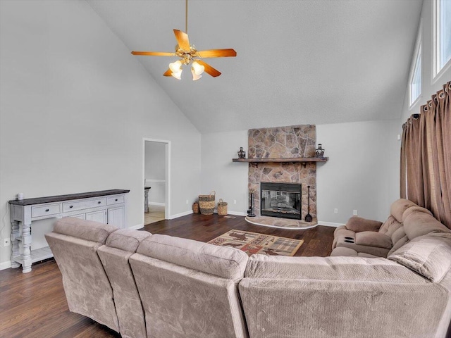 living room with high vaulted ceiling, ceiling fan, dark wood-style floors, baseboards, and a fireplace