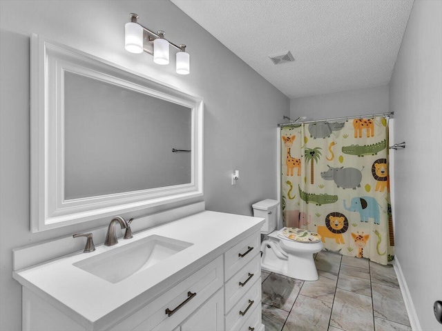 full bathroom featuring a textured ceiling, marble look tile flooring, vanity, toilet, and curtained shower