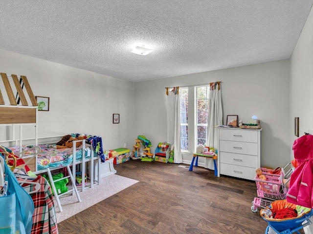 rec room with wood finished floors and a textured ceiling