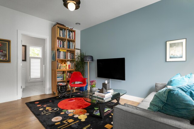 living room featuring wood finished floors and baseboards