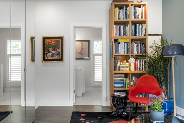 sitting room featuring baseboards and wood finished floors
