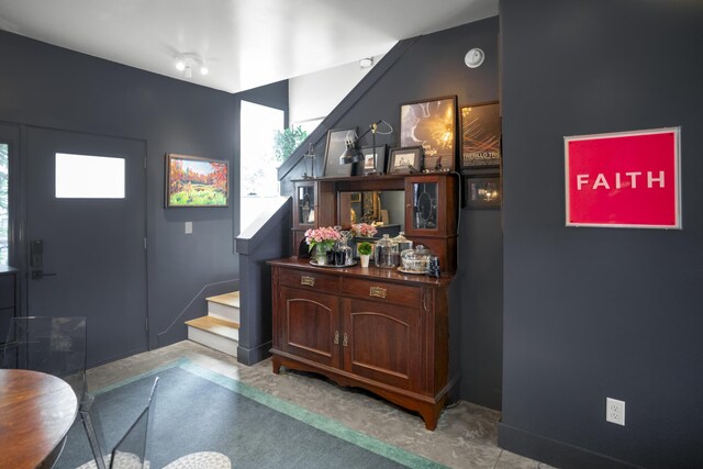 entrance foyer featuring stairway and healthy amount of natural light