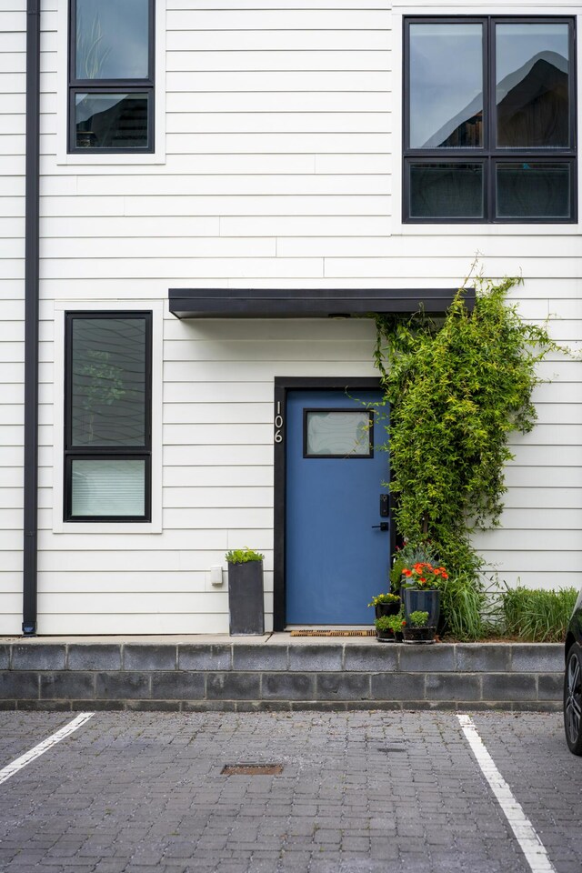 doorway to property featuring uncovered parking