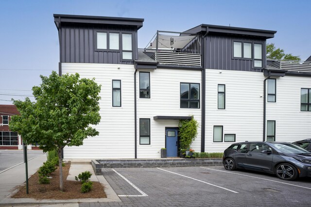 view of building exterior with uncovered parking