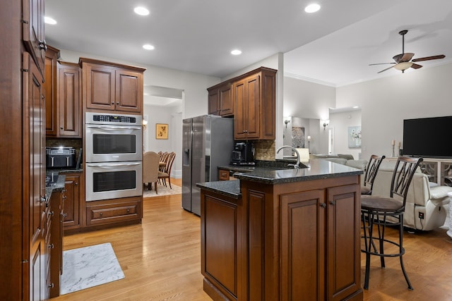 212 Smith St, Signal Mountain, TN 37377 - kitchen featuring appliances with stainless steel finishes, open floor plan, a kitchen breakfast bar, backsplash, and a peninsula