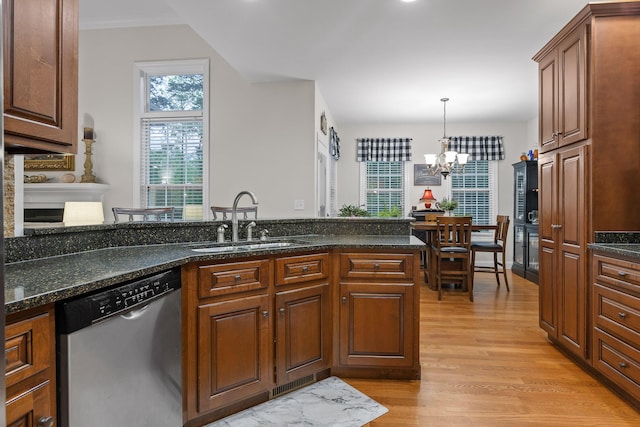 212 Smith St, Signal Mountain, TN 37377 - kitchen with stainless steel dishwasher, a sink, light wood-style floors, a chandelier, and decorative light fixtures