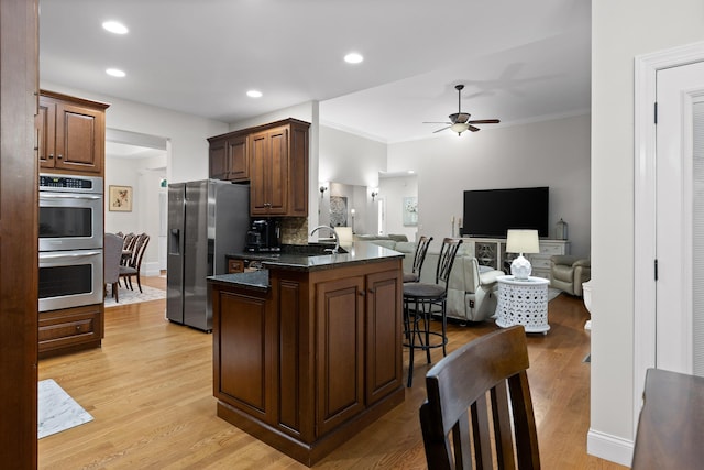 212 Smith St, Signal Mountain, TN 37377 - kitchen with appliances with stainless steel finishes, ornamental molding, a ceiling fan, a kitchen breakfast bar, and a peninsula
