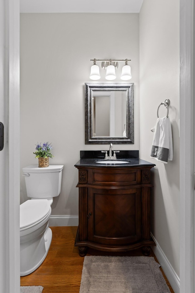 212 Smith St, Signal Mountain, TN 37377 - half bathroom featuring baseboards, toilet, vanity, and wood finished floors