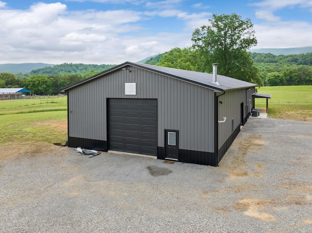 detached garage with a rural view