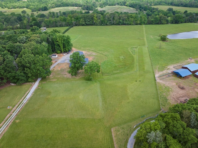 view of property location featuring rural landscape, a pastoral area, and a large body of water