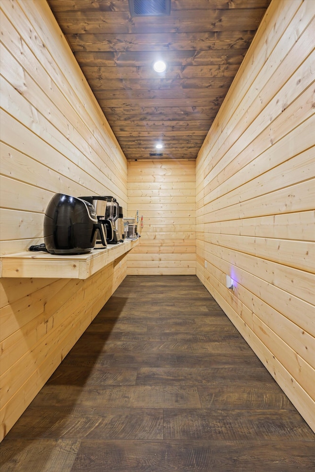 relaxing sauna with wooden ceiling, wood walls, and wood finished floors