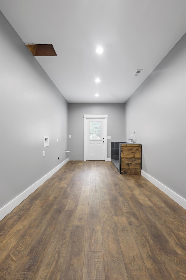 basement featuring baseboards, wood finished floors, and recessed lighting