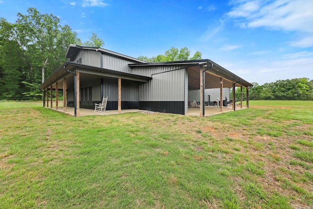 rear view of house with a patio and a yard