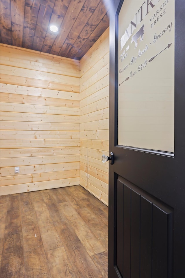 entryway featuring wooden ceiling, wooden walls, and wood finished floors