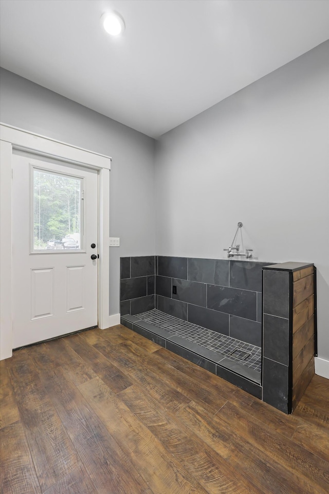 bathroom with wood finished floors and baseboards