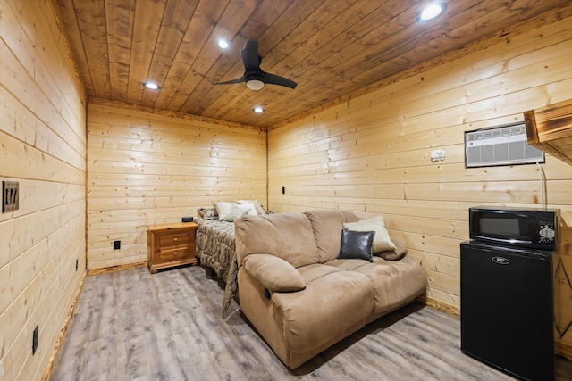 bedroom featuring wood ceiling, refrigerator, recessed lighting, wooden walls, and an AC wall unit