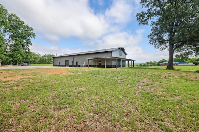 rear view of property with a lawn