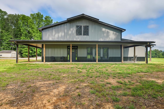 view of front of property with a front yard, a shed, and an outbuilding