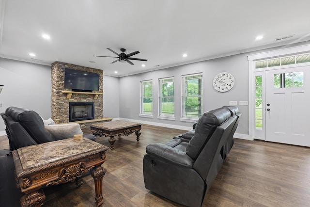 living area with healthy amount of natural light, a stone fireplace, wood finished floors, and recessed lighting