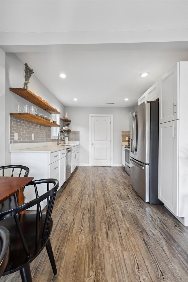 618 Hamilton Ave, Chattanooga, TN 37405 - kitchen featuring appliances with stainless steel finishes, open shelves, white cabinets, dark wood-style flooring, and light countertops