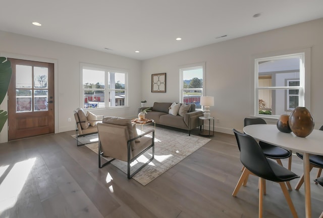 living area with recessed lighting and wood finished floors
