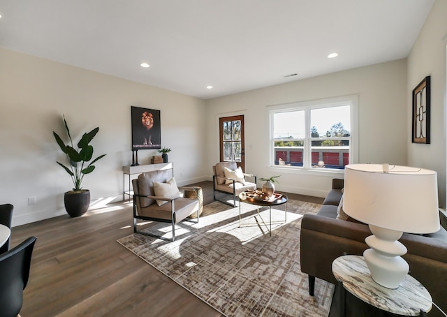 living area featuring wood finished floors, baseboards, and recessed lighting