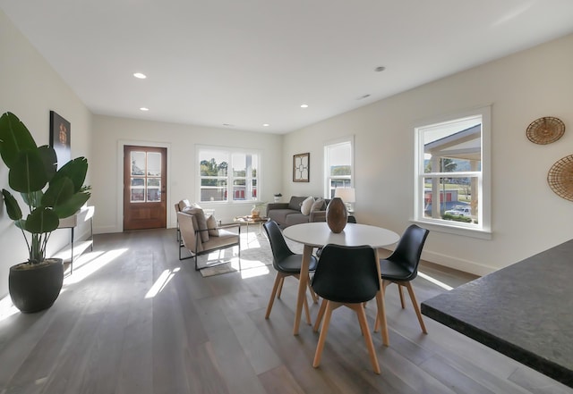 dining space with recessed lighting, baseboards, and wood finished floors