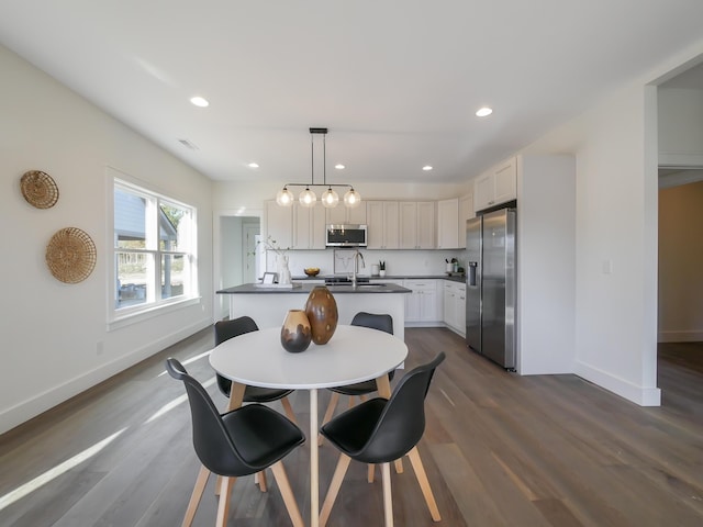dining space featuring baseboards, dark wood finished floors, recessed lighting, and visible vents