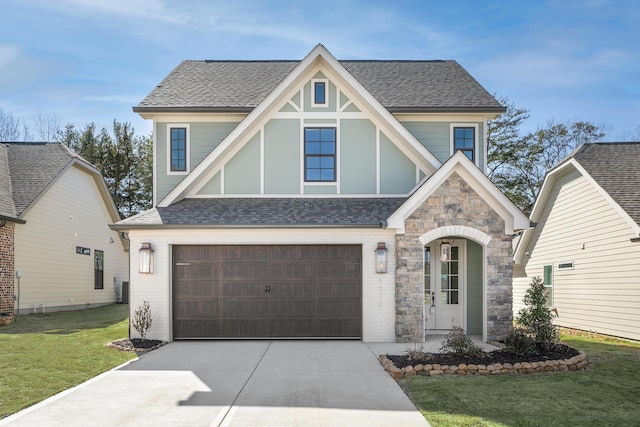 1872 Emmeline Way Unit 09, Hixson, TN 37343 - tudor home with an attached garage, a front yard, driveway, stone siding, and a shingled roof