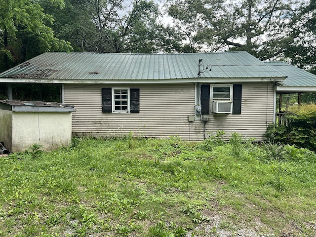 rear view of property with metal roof