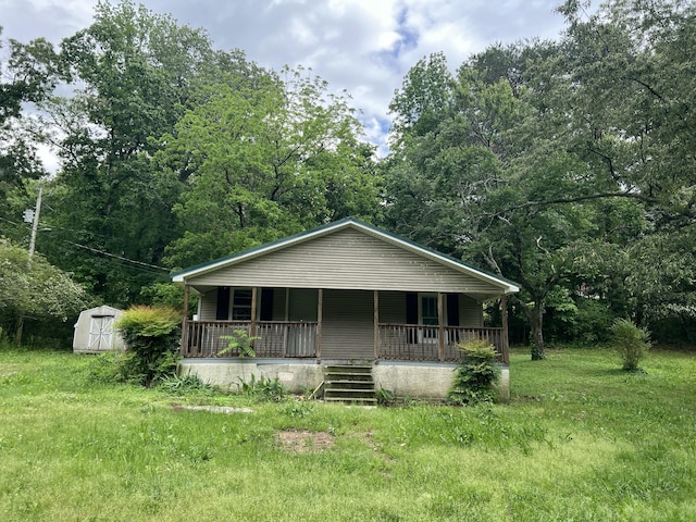 bungalow-style house with a porch, an outbuilding, and a storage unit
