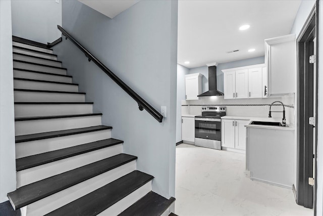 staircase featuring recessed lighting