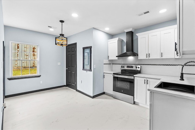 kitchen featuring a sink, wall chimney range hood, stainless steel range with electric stovetop, a chandelier, and backsplash
