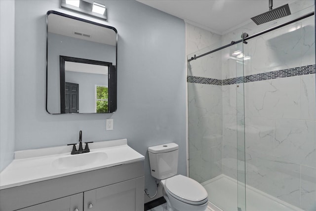 bathroom featuring vanity, toilet, a marble finish shower, and visible vents
