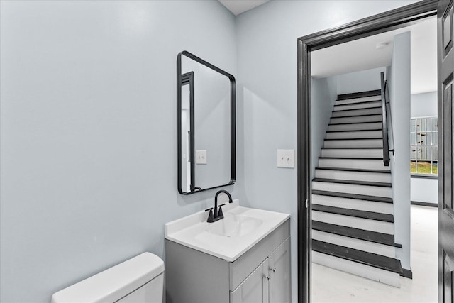 bathroom featuring toilet and vanity