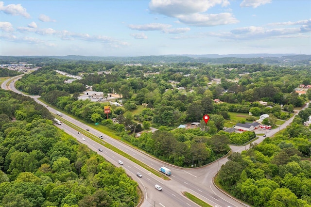 drone / aerial view featuring a wooded view