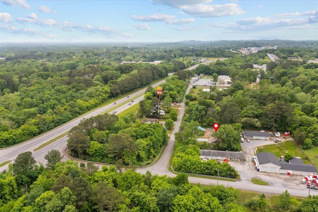 birds eye view of property with a view of trees